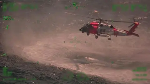 A Coast Guard Air Station New Orleans MH-60 Jayhawk hovers over their rescue swimmer during a rescue Sunday, approximately 25 miles offshore from Empire, Louisiana