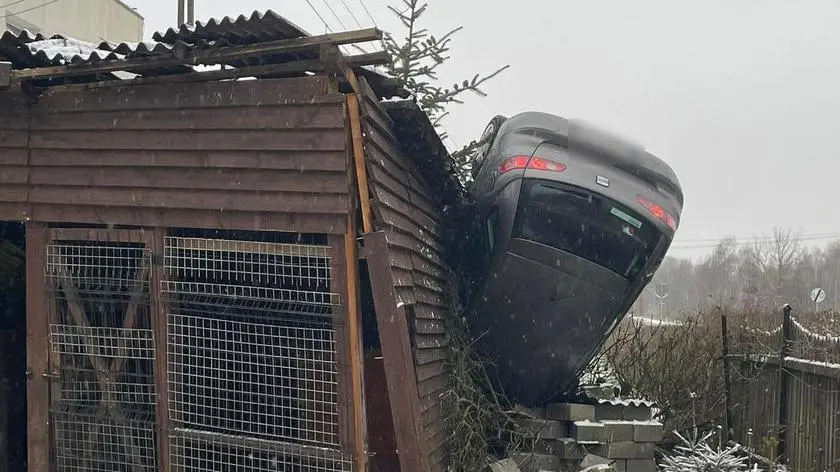 Wjechał w drewnianą szopę. Auto dachowało i zawisło na dachu budynku