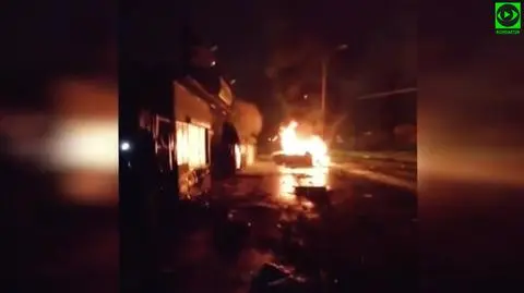 Wypadł z drogi, uszkodził ogrodzenie i sklep, zatrzymał się na słupie. Auto stanęło w płomieniach 