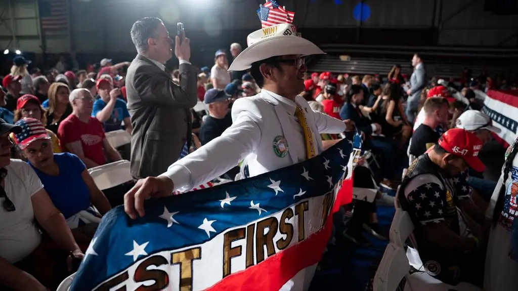 Supporters of US President Donald Trump attend a rally to celebrate his 100 days in office in Warren, Michigan