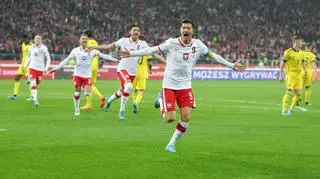 Robert Lewandowski celebrates after scoring agains Sweden in play-off game against Sweden