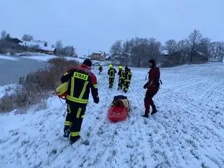 Jeden ze strażaków dotarł kajakiem ratowniczym po lodzie do tonącego psa