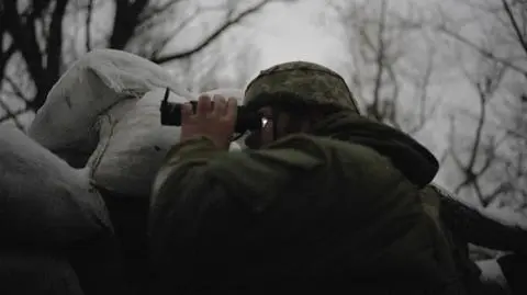  Ukrainian soldier uses a night vision scope to observe the area from the frontline in Zolote, Ukraine on January 20, 2022