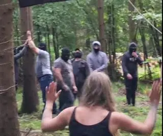 The masked men tried to force one activist to come down from a tree
