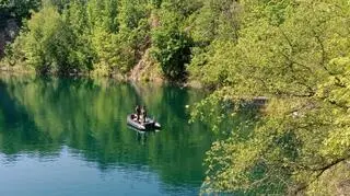 Sappers and divers search the flooded quarry