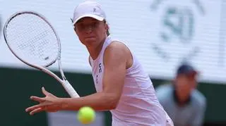 Poland's Iga Świątek plays a forehand return to Czech Republic's Karolina Muchova during their women's singles final match on day fourteen of the Roland-Garros Open tennis tournament