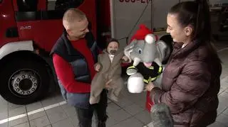 The firefighters gave the boy an elephant-firefighter mascot