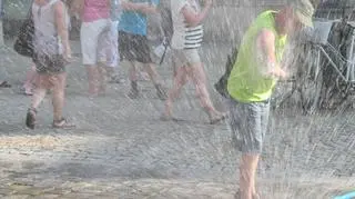 Mieszkańcy chłodzą się przy kurtynach wodnych