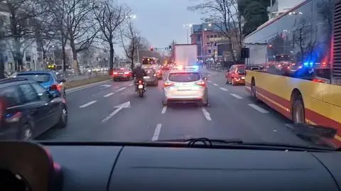 Police cars escort ambulance with heart for a transplant