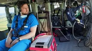 A heart surgeon keeping an eye on the box with the heart inside