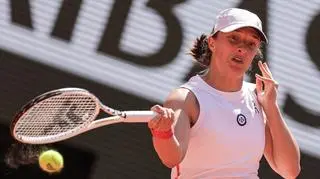 Poland's Iga Świątek plays a forehand return to China's Wang Xinyu during their women's singles match on day seven of the French Open