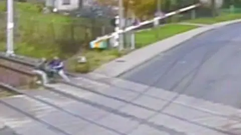 The man collapsed onto the tracks exactly when the gates started to go down