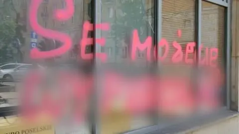 A woman wrote slogans in pink paint all over one of the Law and Justice offices in Warsaw