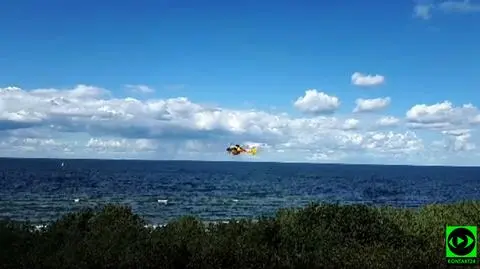 Search and Rescue helicopter flying above the Baltic Sea shore