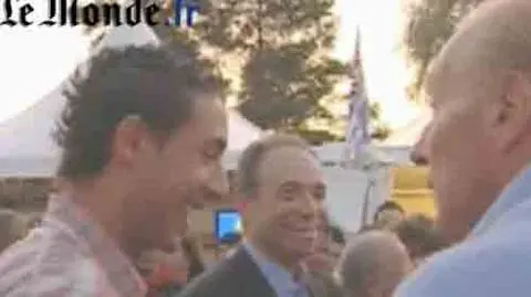 Minister Brice Hortefeux (w niebieskiej koszuli) rozmawia z młodym arabskim działaczem ( w czerwonej koszuli w kratę)