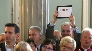 Bogdan Klich podczas spotkania klubu PO trzyma kartkę z dokładną liczbą osób, które zagłosowały na Bronisława Komorowskiego