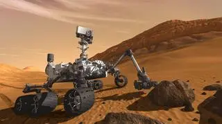 Grafika pokaująca "Curiosity" na powierzchni Marsa. Łazik ma 3m długości i waży niemal tonę (Fot. NASA)