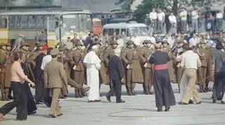 Papież Jan Paweł II w towarzystwie przewodniczącego Rady Państwa Henryka Jabłońskiego przechodzi przed dwuszeregiem żołnierzy. Za papieżem idzie m.in. prymas Polski, kard. Stefan Wyszyński - 1979-06-10