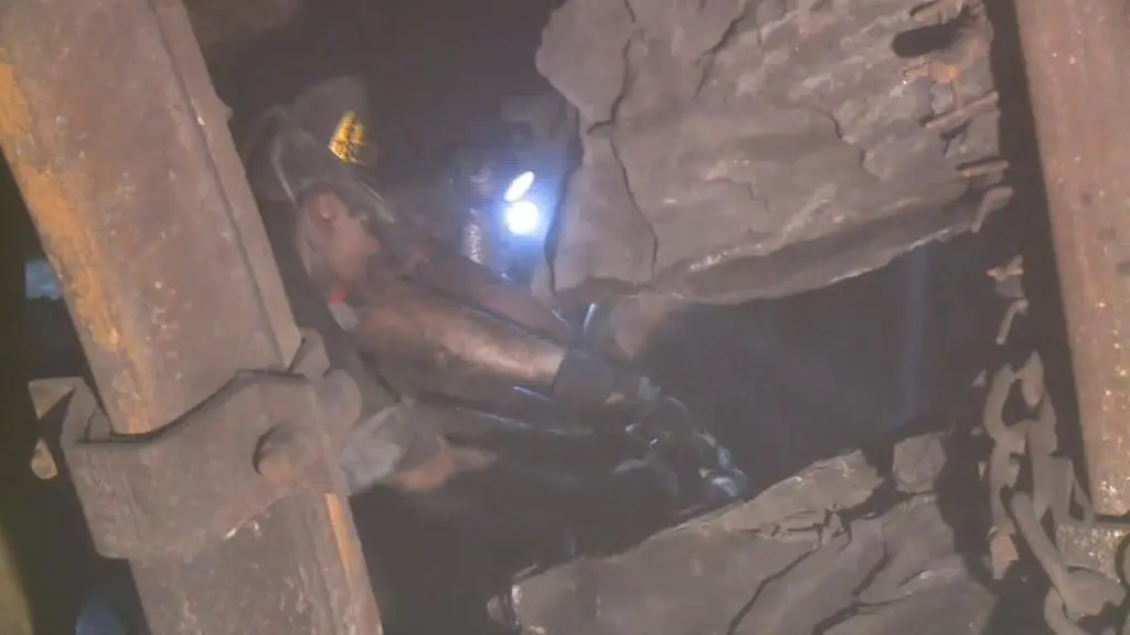 The rescuers are forced to cut through contorted mining equipment