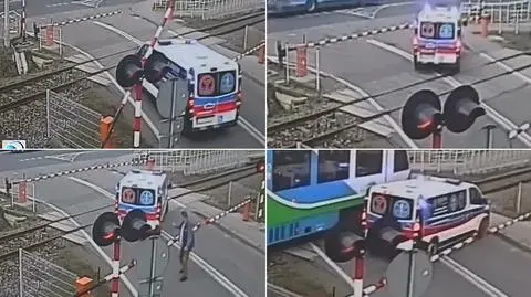 Karetka stoi na przejeździe, szlabany opadają