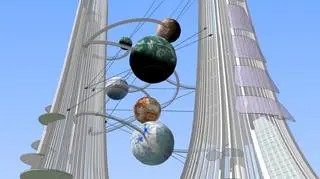 Pomiędzy wieżami zawisną kule symbolizujące planety 