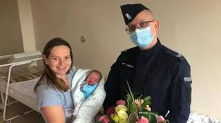 The officer helped the woman to deliver at a parking lot in front of the hospital