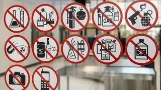 Naklejki znaków zakazu na szybie przed kontrolą bezpieczeństwa