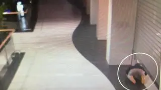 The man slid under a steel gate into a clothing store