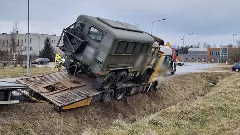 Laweta z wojskową ciężarówką zawisła w rowie