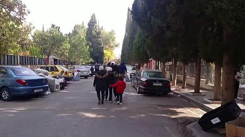 Syrians walk through the Presidential Palace in Damascus. They entered there after Assad was overthrown