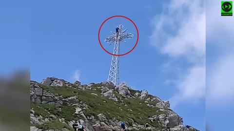 Reckless tourist climbs up the Giewont peak cross