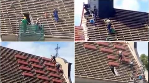 Robotnicy pracujący na dachu kościoła bez zabezpieczeń