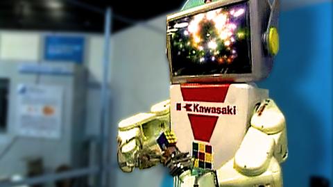 Robot uczy młodych Japończyków układania kostki Rubika
