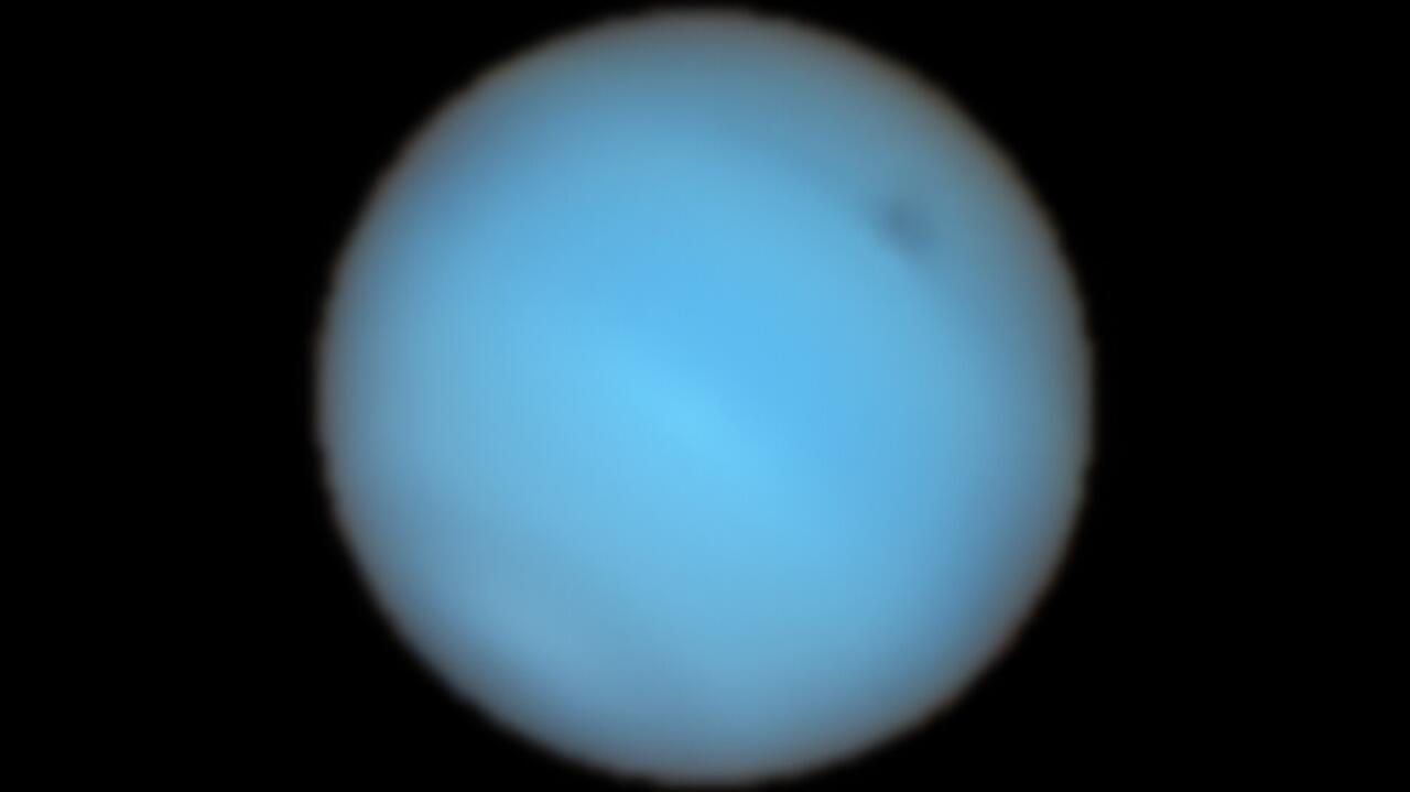 Dark spot on Neptune.  It has been observed from Earth