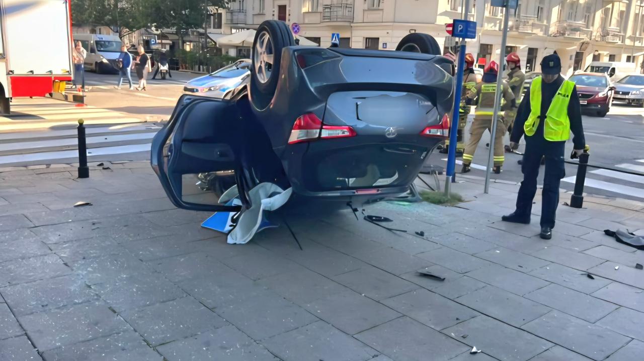 Auto dachowało na chodniku po zderzeniu z radiowozem